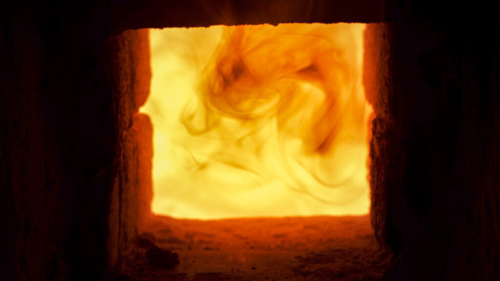 Close -up shot that A hot flame is burning in a porcelain kiln.